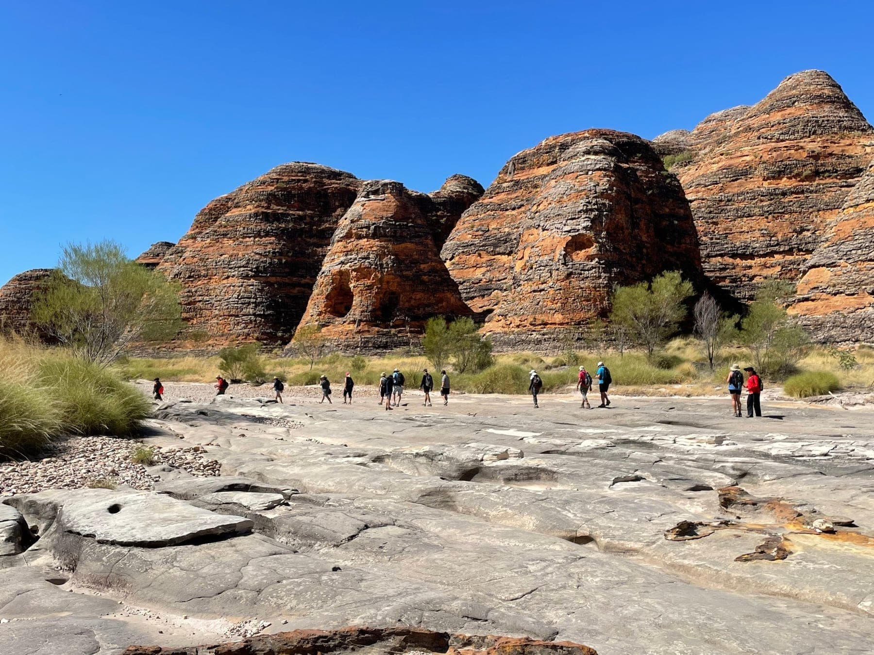 Walkers crossing the wide rock slabs of Piccaninny Creek
