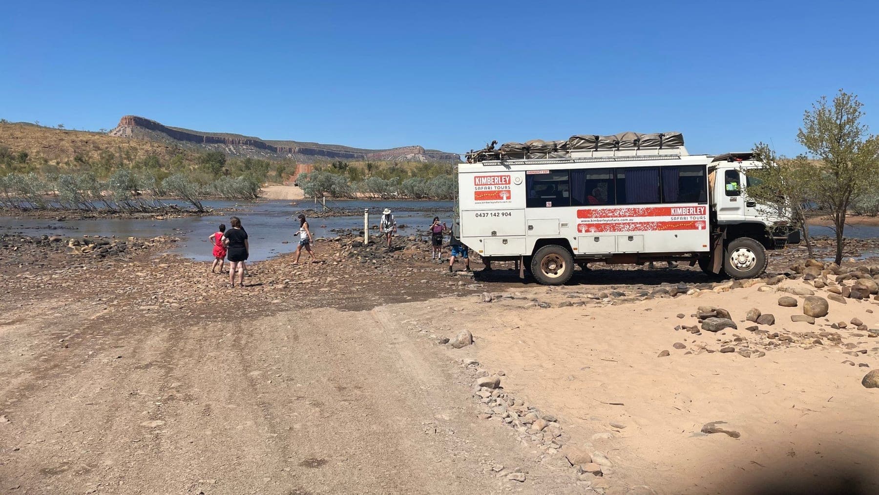 The tour coach crossing the Pentecost River below the Cockburn Ranges